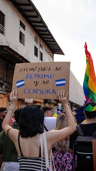 Protesters hold signs advocating for LGBTQ+ rights at a rally in Panama City.